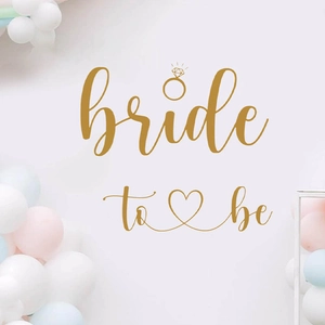Elegant gold Bride to Be wall decal with ring and heart accents for bridal shower party decor