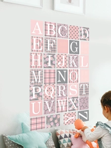 Alphabet wall decals with floral patterns in a cozy nursery setting on a white wall