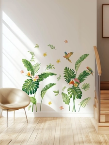 Detail of tropical monstera leaves and parrots wall decal on a staircase wall
