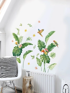 Close-up of tropical palm leaves and colorful parrot wall stickers for home decor