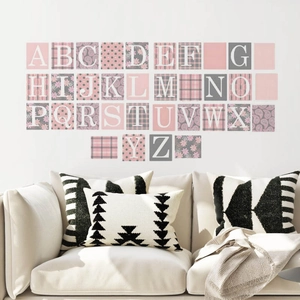 Pink and grey alphabet wall stickers with floral patterns above a modern white sofa