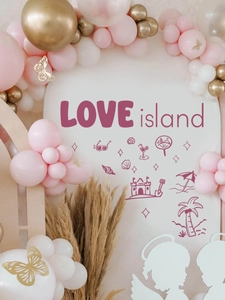 Detailed close-up of Love Island party background with pink balloons and golden butterflies