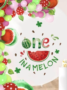 Detail of watermelon theme first birthday backdrop with one in a melon banner and balloons