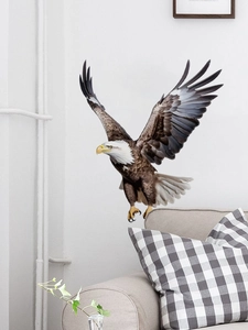 Detailed realistic eagle wall sticker with spread wings on a living room sofa background