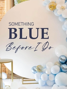 Detail of Something Blue bridal shower backdrop with elegant balloon arch and white round board
