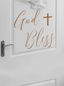 Self-adhesive brown God Bless wall decal with cross symbol on a white wooden door