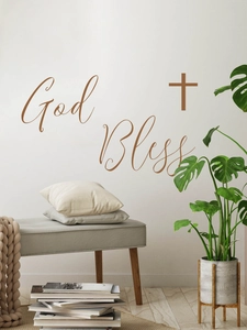 Detail of God Bless wall sticker with cross symbol in a cozy Nordic living room