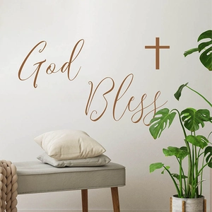 Brown God Bless wall decal with cross sign over a bench in a cozy living room scene