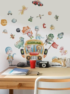 Detail of school bus and dinosaur wall stickers on white wall above a wooden desk