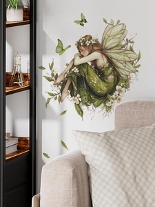 Detail of green butterfly fairy wall sticker above a sofa for living room decor