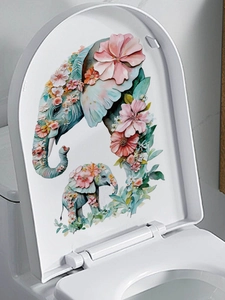 Detail of floral elephant mother and baby decal on a white toilet lid in bathroom