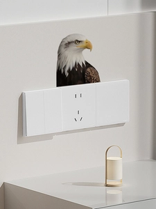 Realistic eagle wall decal interacting with a white triple light switch panel on wall