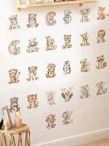Detail of 26 animal alphabet wall stickers in a cozy nursery room setting