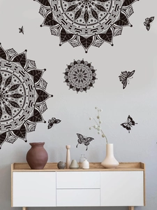 Detail of black mandala flower wall stickers with butterfly accents in living room