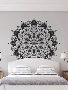 Detailed view of black mandala wall sticker with intricate geometric patterns on a white wall