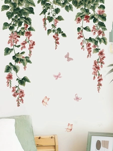 Detail view of floral wall decals featuring pink butterflies and green vine stickers