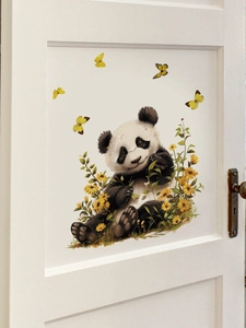 Detail of cute panda wall sticker with yellow butterflies and flowers on white wooden door
