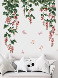 Detail of floral wall decals featuring pink flowers and butterflies over a white sofa