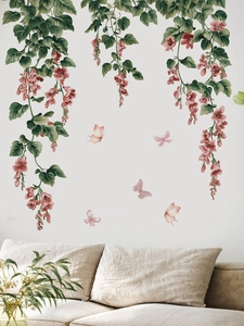 Pink floral vine wall decals with butterflies above a beige sofa in a cozy living room