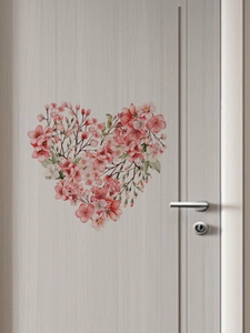Detailed view of pink floral heart wall sticker made of PVC on a textured light wood door