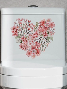 Detail of a pink floral heart-shaped sticker made of cherry blossoms on a toilet tank