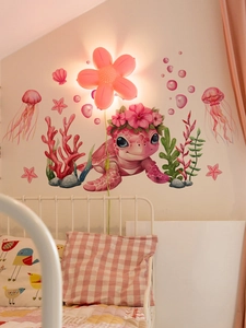 Detailed view of pink turtle and sea life wall stickers in a cozy child bedroom decor