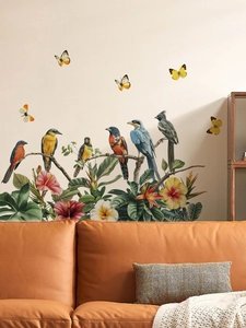 Detail of colorful tropical birds, flowers, and yellow butterflies on a PVC wall sticker