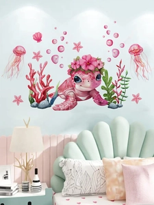 Detail of pink sea turtle and jellyfish wall stickers in a cozy blue kids bedroom scene