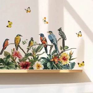 Vibrant wall stickers featuring realistic flowers, birds, and butterflies on a clean wall