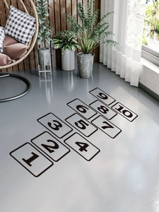 Perspective view of black hopscotch numbered grid wall stickers in a modern living room