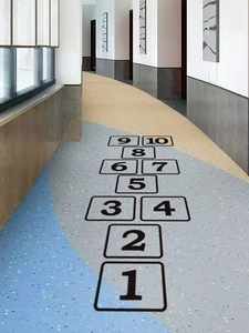 Detail showing self-adhesive black numbered floor stickers for kids' indoor hopscotch game