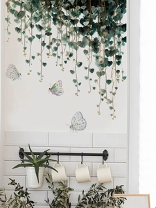 Detail of PVC hanging vine wall decals with watercolor butterflies on a clean white wall