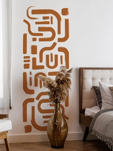 Detail of modern abstract wall decal with terracotta fluid lines in a minimalist bedroom