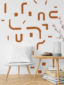 Abstract geometric wall decals in terracotta tones styled in a modern living room setting