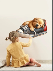 Detail of 3D puppy in shoe wall sticker displayed on wall with a child for scale