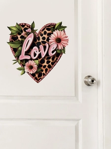 Detail of leopard print heart wall sticker with Love text on a white door