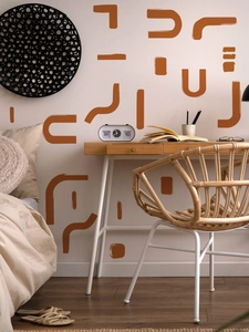 Close-up of terracotta geometric wall decals with matte finish in a boho home setting
