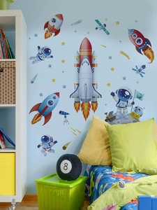 Detail view of colorful space rocket and astronaut wall stickers in a kids bedroom