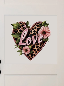 Detail of leopard print heart wall sticker with pink Love text and daisies on white door