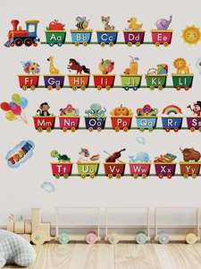 Detail of colorful alphabet train wall decal featuring cartoon animals on a white wall