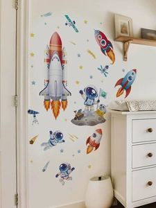 Space astronaut and rocket wall decals set applied on a clean white bedroom wall