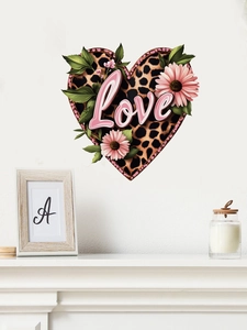 Detail of leopard print heart wall decal with pink daisies and Love text in a cozy room