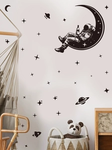 Space wall decals featuring astronaut on moon with rockets and stars on white wall