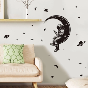Black astronaut silhouette wall stickers featuring moon and planets for home decor