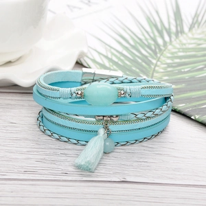 Detail of bohemian multilayer woven bracelet with turquoise stone and magnetic clasp