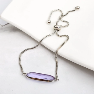 Detailed view of adjustable silver box chain with oval purple zircon crystal stone