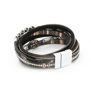Detail of bohemian multilayer leather bracelet with rhinestones and magnetic buckle