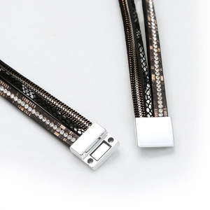 Detailed close-up of multilayer leather bracelet with rhinestones and magnetic clasp