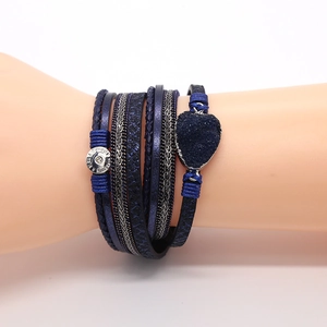 Detail van een meerlaagse blauwe gevlochten leren armband met hartsteen en magneetsluiting