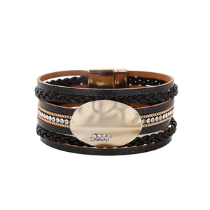 Close-up of multilayer leather bracelet with rhinestone chains and magnetic buckle clasp
